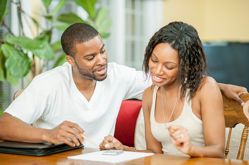 a man and a woman are Reviewing Homeowner Insurance Needs